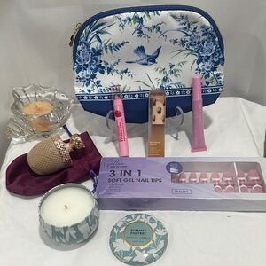 Floral Blue and White Cosmetic Bag with a makeup brush, candle nails & lip oils